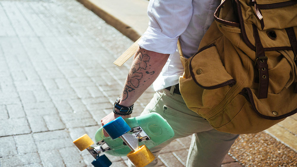 Young Hip Guy with tattoos on Skateboard - Nashville's Local Hotspots